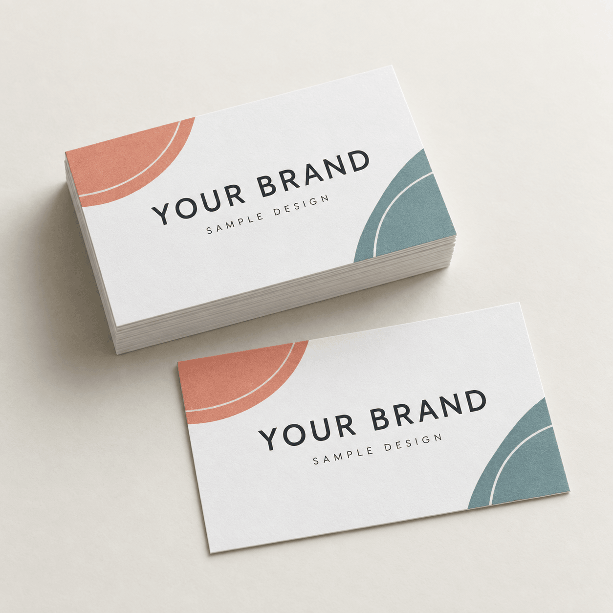 Sample 3.5 × 2 inch rectangular business cards with coral and teal artwork on white cover stock.